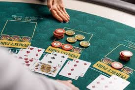 Screenshot of liga123 login app showing live casino tables with blackjack, roulette, and baccarat games